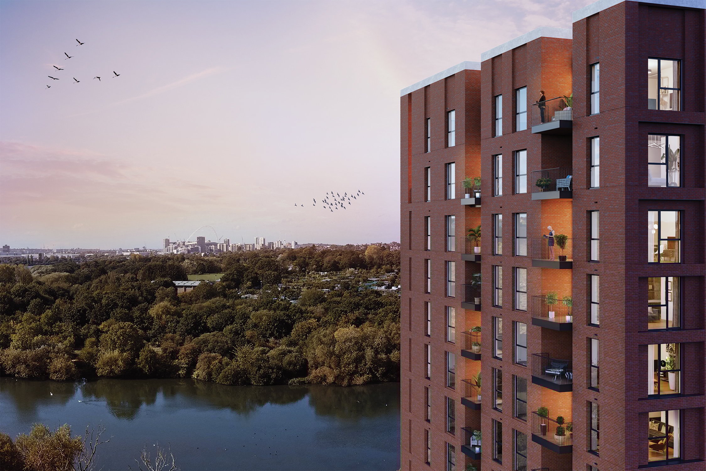 Image of a property development set next to a large green space with the City in the background.