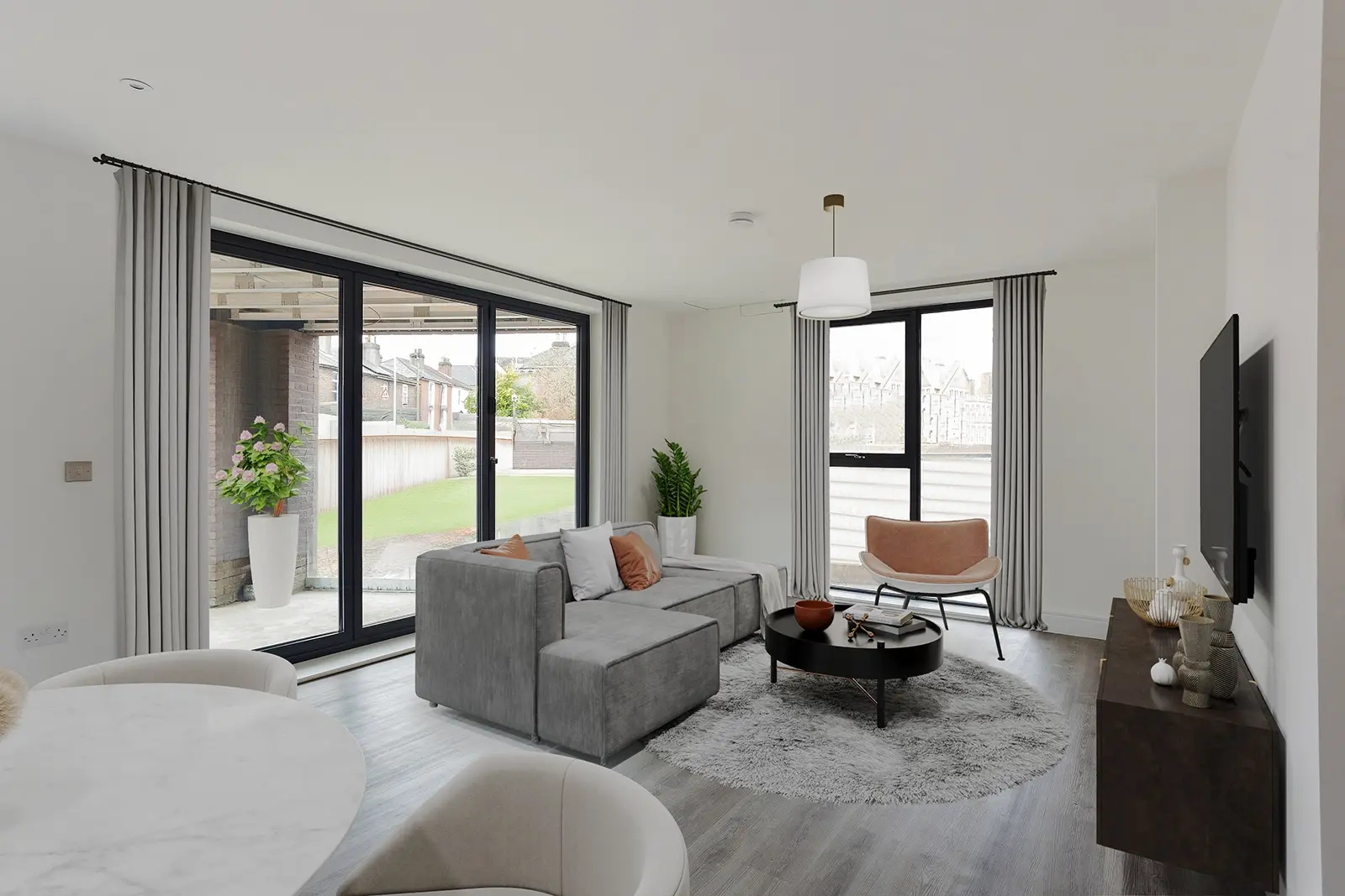 A living room with sofa, coffee table and chairs